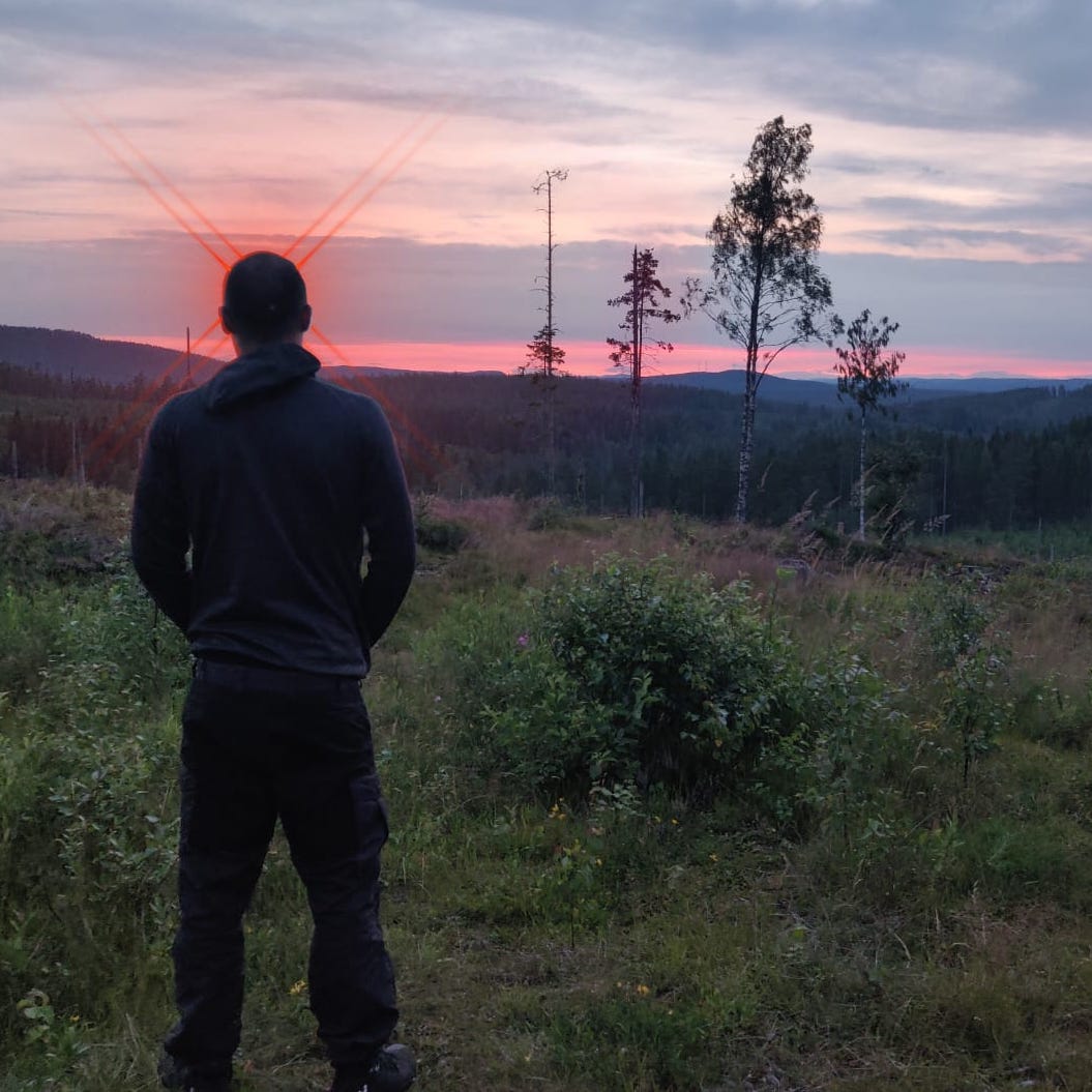 Idse Val looking away into a red sunset with red laser eyes